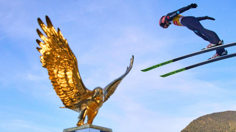 Karl Geiger, GER in flight action in front oft the Golden Eagle trophy at the 70